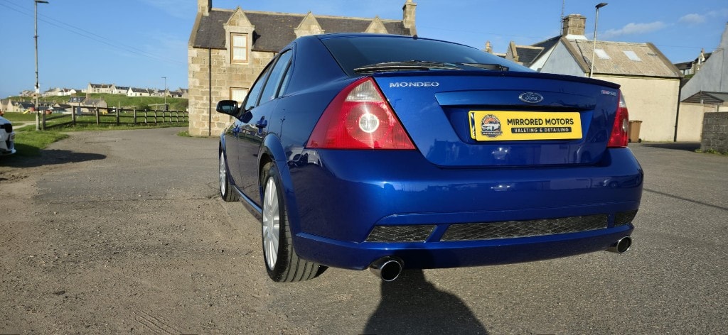 Detailed blue Ford Mondeo rear end with polished paintwork