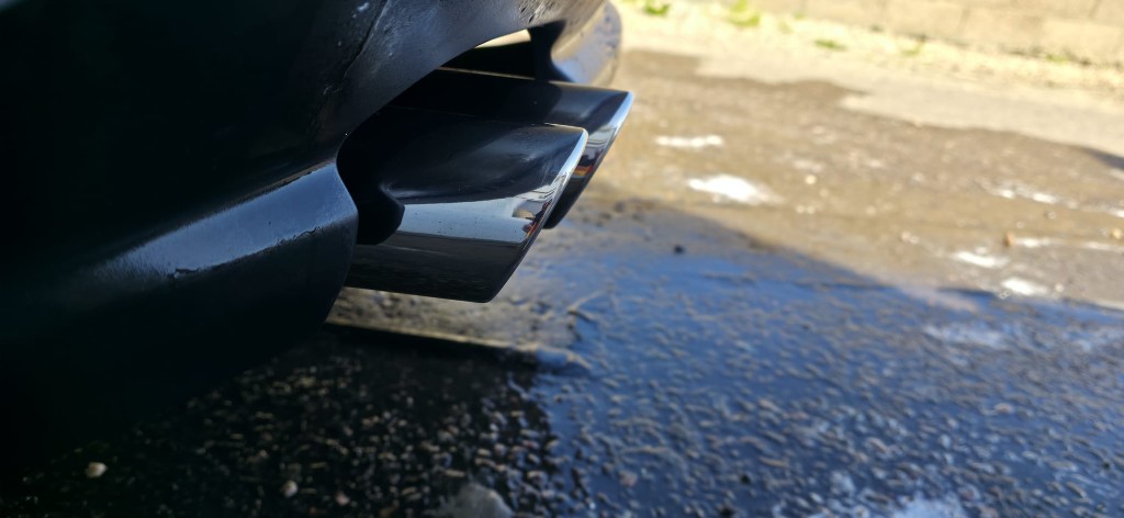 Gleaming, mirror-polished exhaust tip after detailing