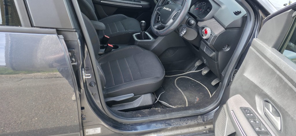 Dirty front footwell and seats before an interior clean